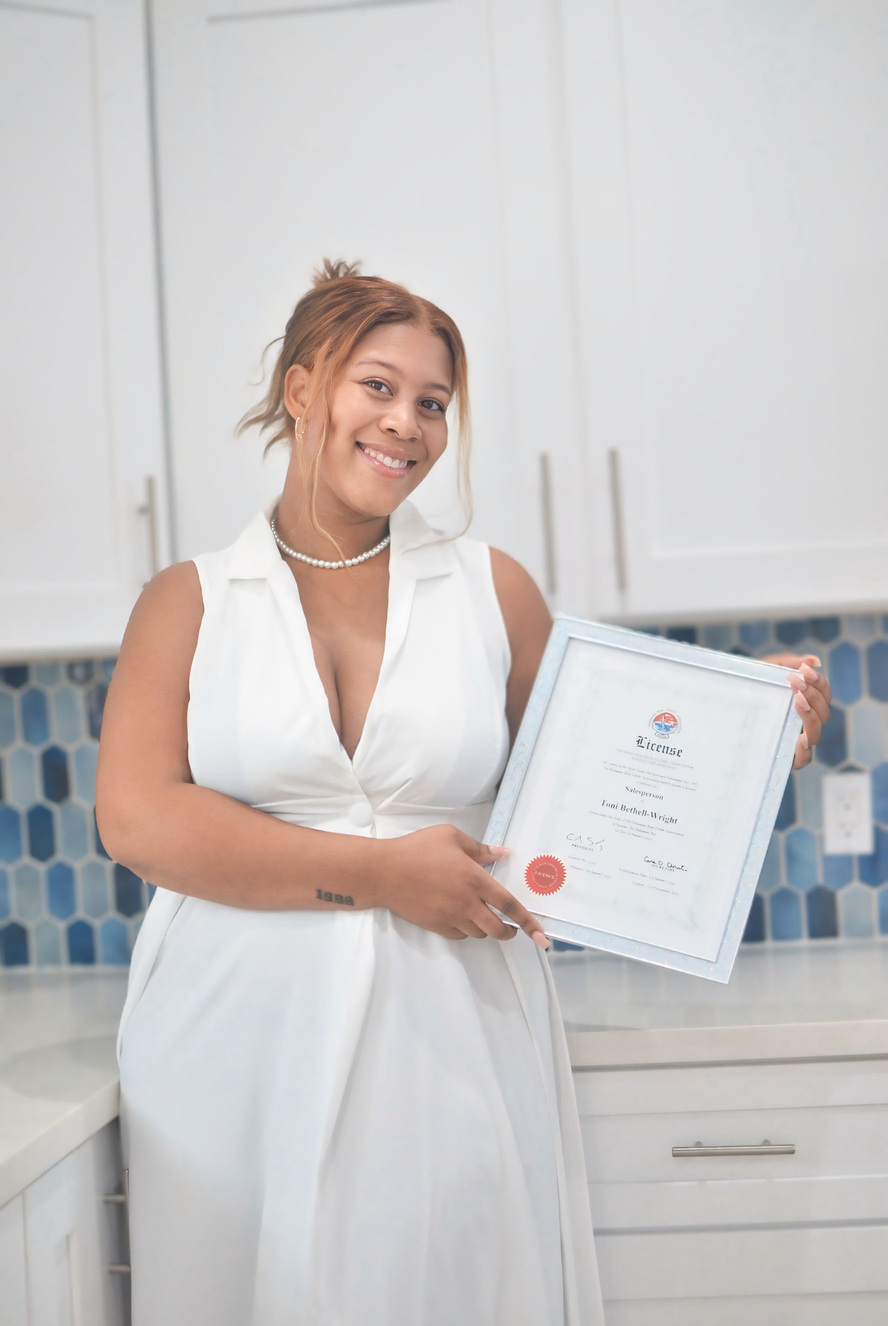 Toni Wright holding her real estate license